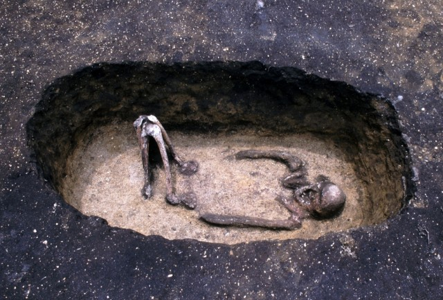 Pit grave and human bone dyed red